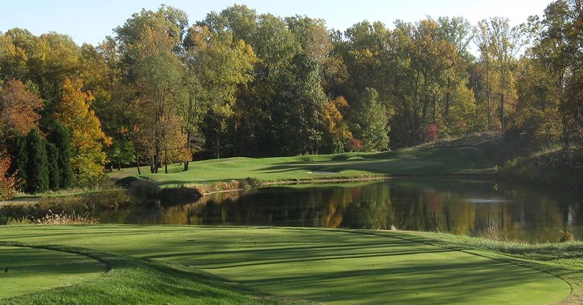 Scenic golf hole at Bethesda Country Club with lake and autumn trees