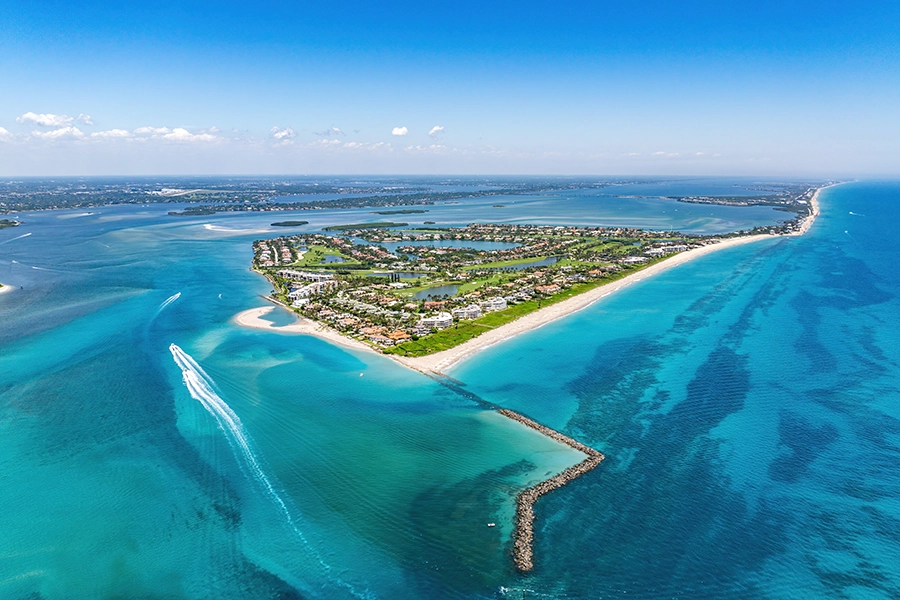 Aerial view of a coastal peninsula community surrounded by blue water